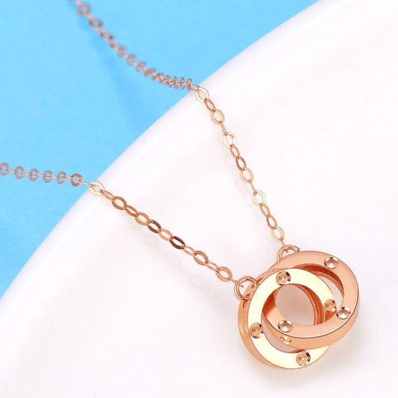 Strovlin 14K rose gold double ring pendant necklace for women, featuring elegant layered rings on a delicate chain.