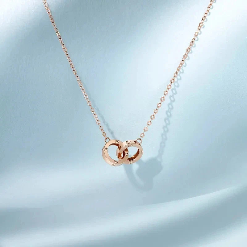 Strovlin 14K rose gold double ring pendant necklace for women, featuring elegant circular design on a delicate chain.