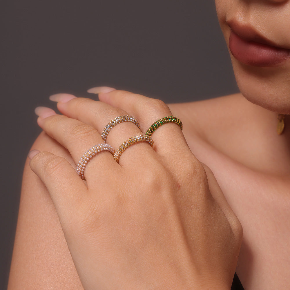 Unisex 18K gold pearl ring with PVD titanium steel band from Strovlin, featuring a polished gold finish and a central pearl.