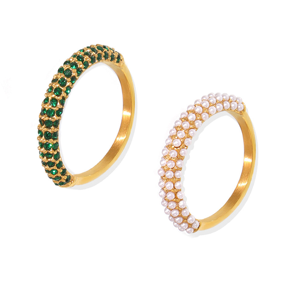 18K gold pearl ring with PVD titanium steel band, unisex design, by Strovlin, showcasing a polished pearl centerpiece and sleek metal finish.